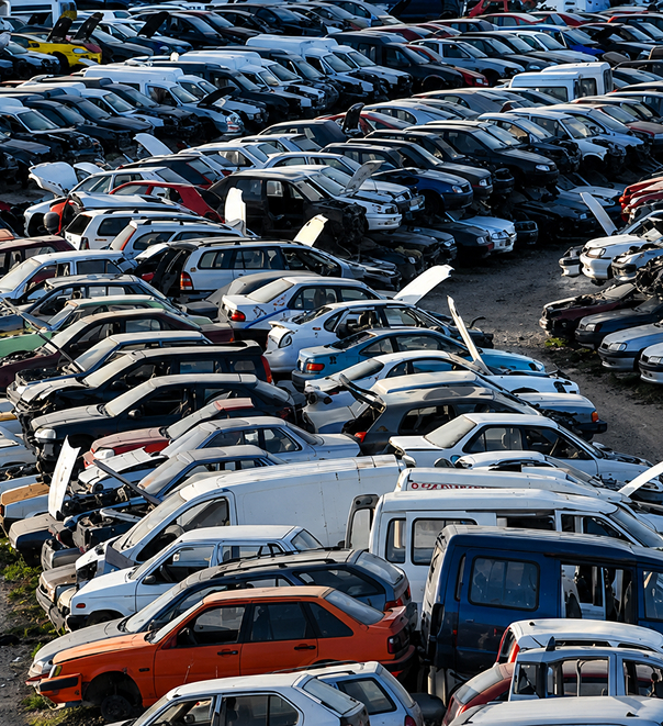 auto-salvage-yard-rows-of-scrapped-vehicles Rows of scrapped and salvaged vehicles stacked in an auto recycling yard